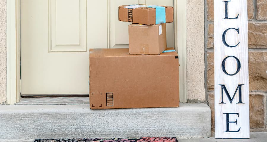 Boxes by the door of a residence with a welcome sign in Salem